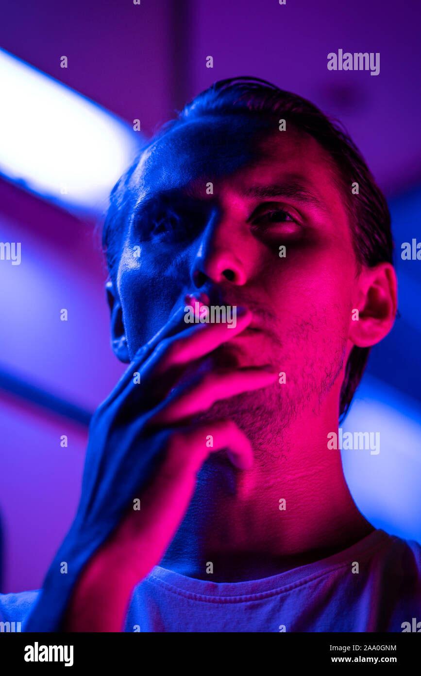 Modern Red And Blue Light Portrait Of A Young Man. Streetlights Visible In  The Background. Stock Photo, Picture and Royalty Free Image. Image  133902917.
