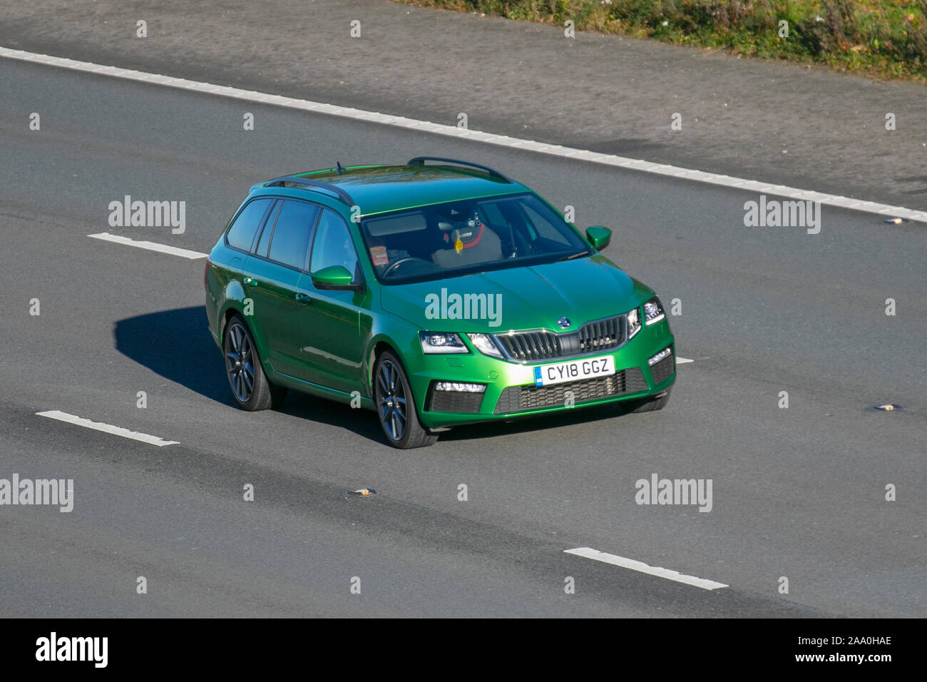 2018 green Škoda Octavia VRS TDI; UK Vehicular traffic, transport, modern vehicles, saloon cars, south-bound motoring on the 3 lane M6 motorway highway. Stock Photo