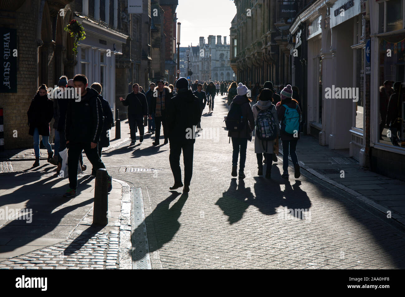 Crowds of people and winter shadows on Trinity Street Cambridge Stock Photo