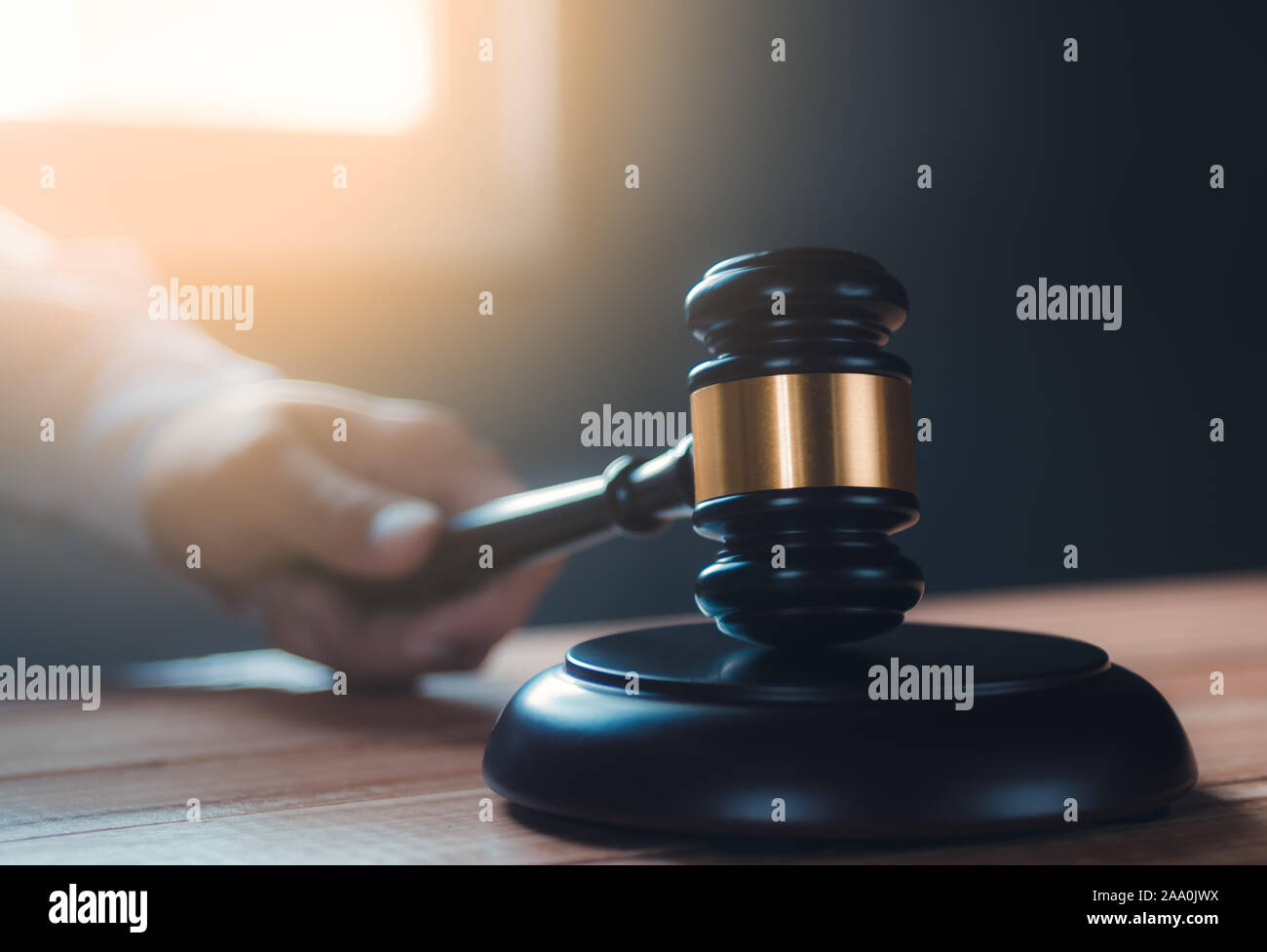 part of man's hand while banging the gavel Stock Photo