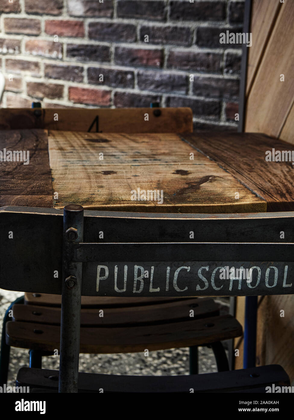 Table detail of a Industrial style Restaurant with a Antique Metallic Chair of a Public School. Stock Photo