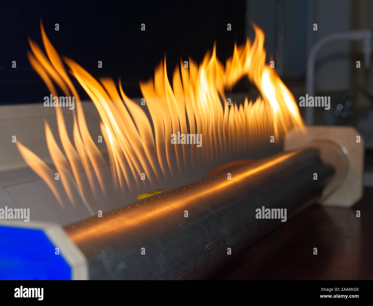 Rubens standing wave flame tube with flames showing resonance in a school science lab. Scientific education concept. Stock Photo