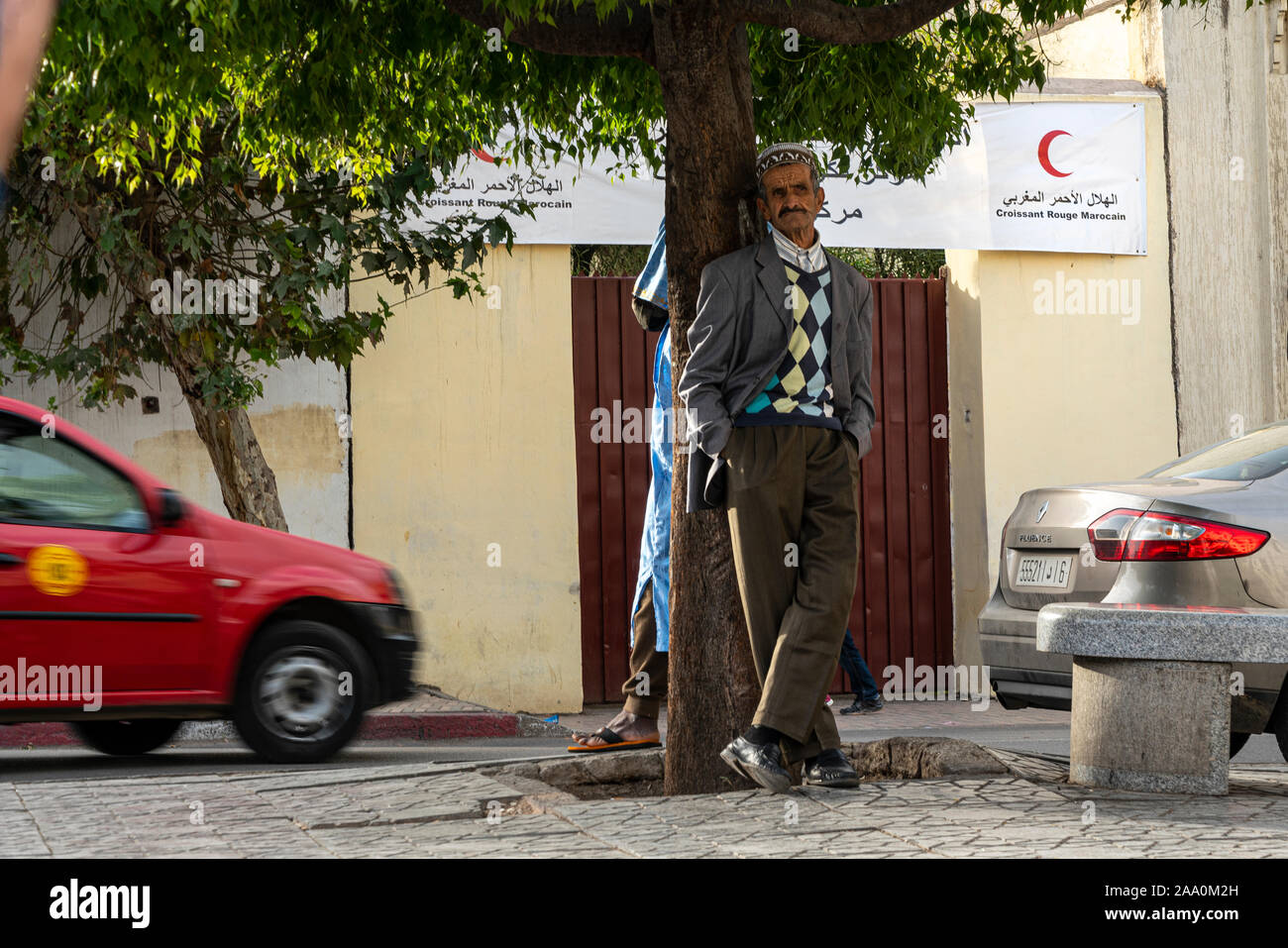 Fez, Morocco. November 9, 2019.  an old man under the tree in a square Stock Photo