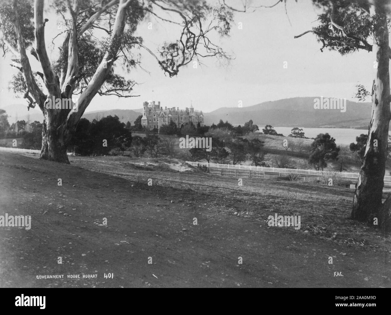 Black and white landscape photograph of a rural area featuring Government House, the official residence of the Governor of Tasmania in Hobart, Tasmania, Australia, by photographer Frank Coxhead, 1885. From the New York Public Library. () Stock Photo