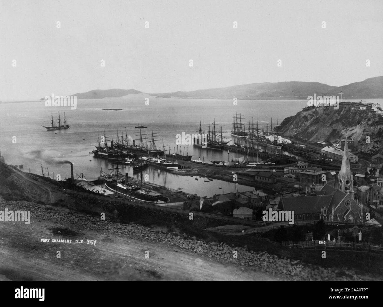 Black and white landscape photograph of Port Chalmers, a suburb and the main port of the city of Dunedin, South Island, New Zealand, by photographer Frank Coxhead, 1885. From the New York Public Library. () Stock Photo