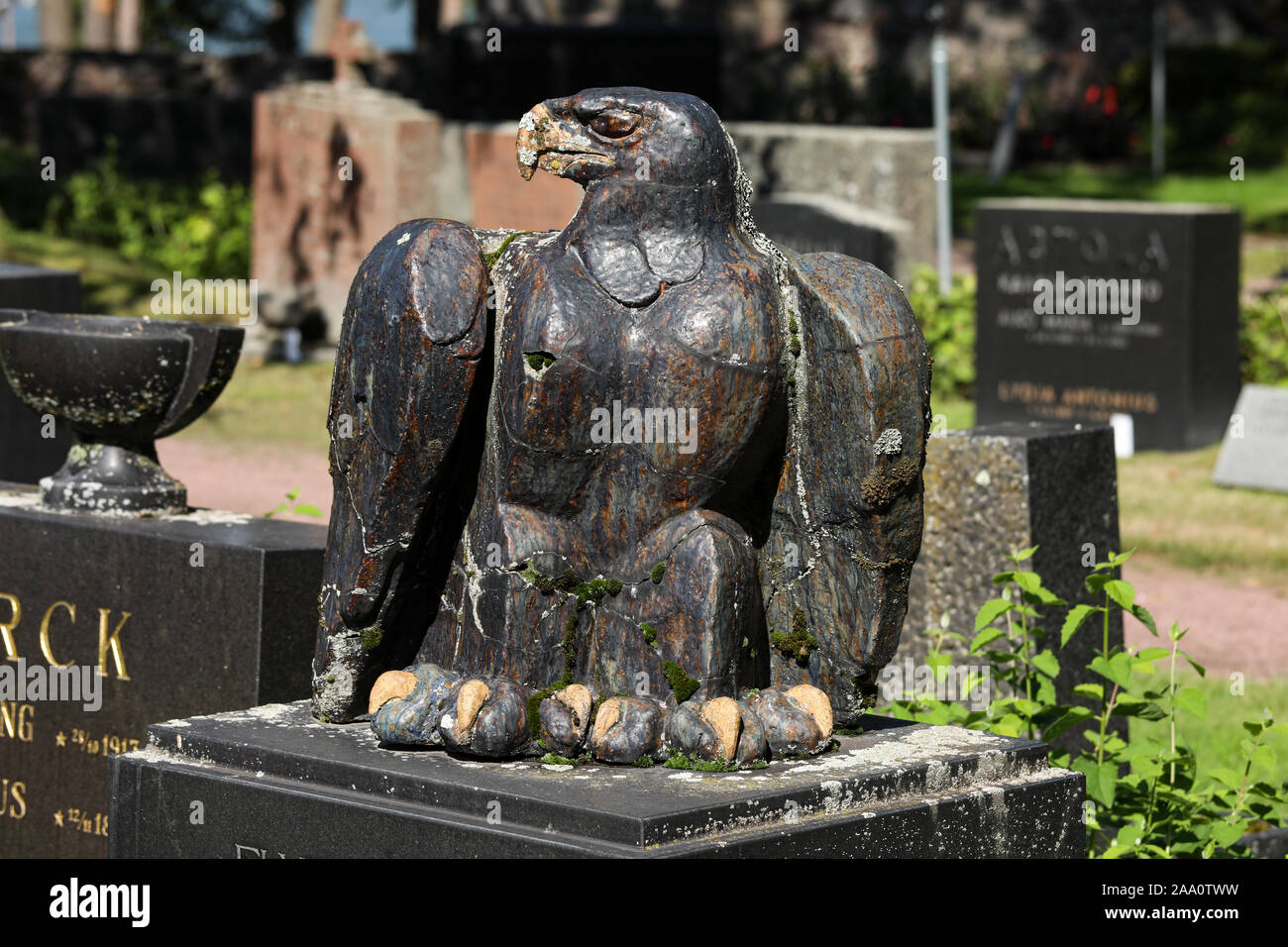 Stone sculpture eagle on gravestone in Hietaniemi Cemetery in Helsinki, Finland Stock Photo