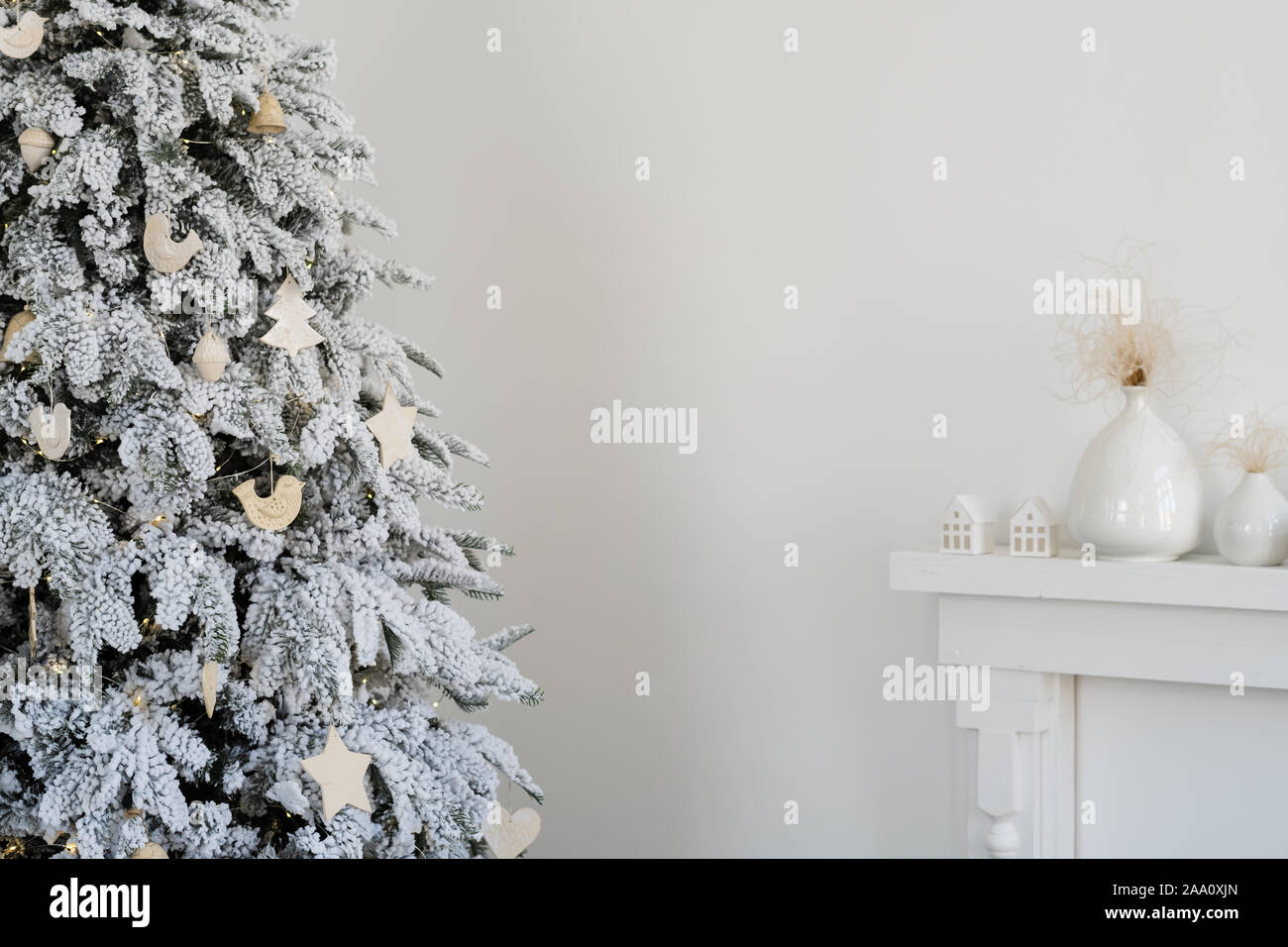 New Year's interior in bright colors. Christmas tree, toys, white fireplace. Stock Photo
