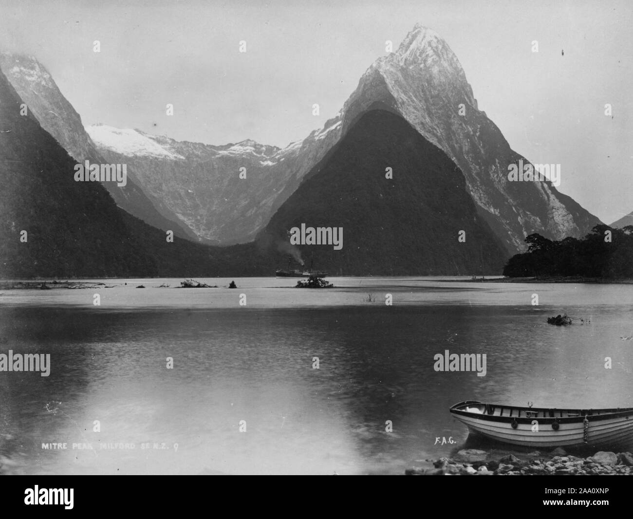 Black and white landscape photograph of the Mitre Peak Mountain and Milford Sound, one of the fjords that form the coast of Fiordland in the South Island, New Zealand, by photographer Frank Coxhead, 1885. From the New York Public Library. () Stock Photo