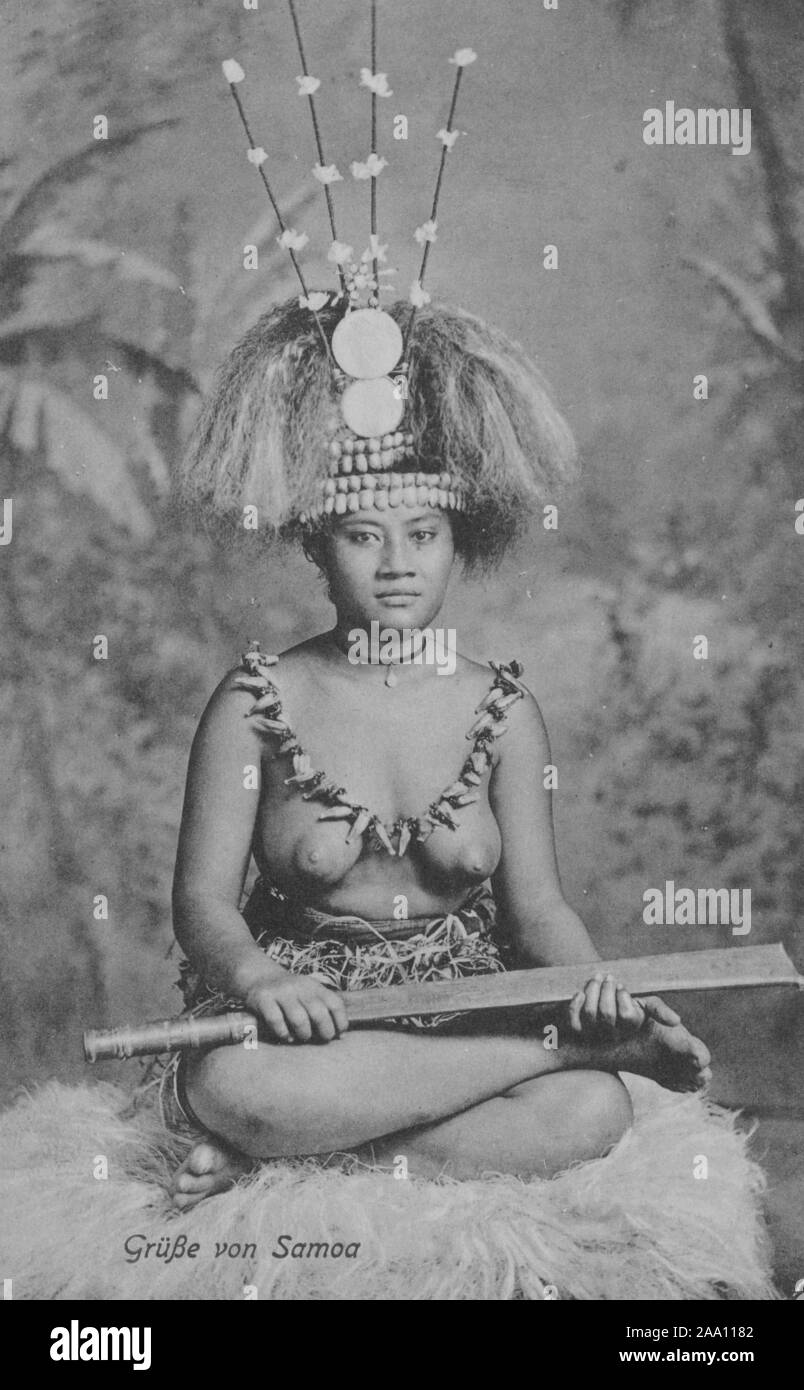 Monochrome postcard of a Samoan taupou hostess sitting in a lotus position wearing a traditional Samoan headdress and holding a ceremonial dancing knife, Samoa Islands, Polynesia, by photographer A. J. Tattersall, 1916. From the New York Public Library. () Stock Photo