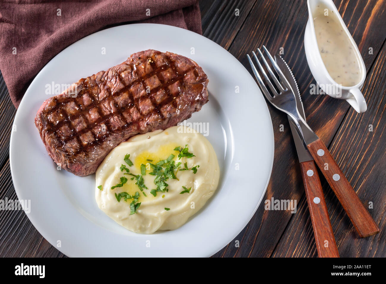 Strip steak with celery puree top view Stock Photo Alamy