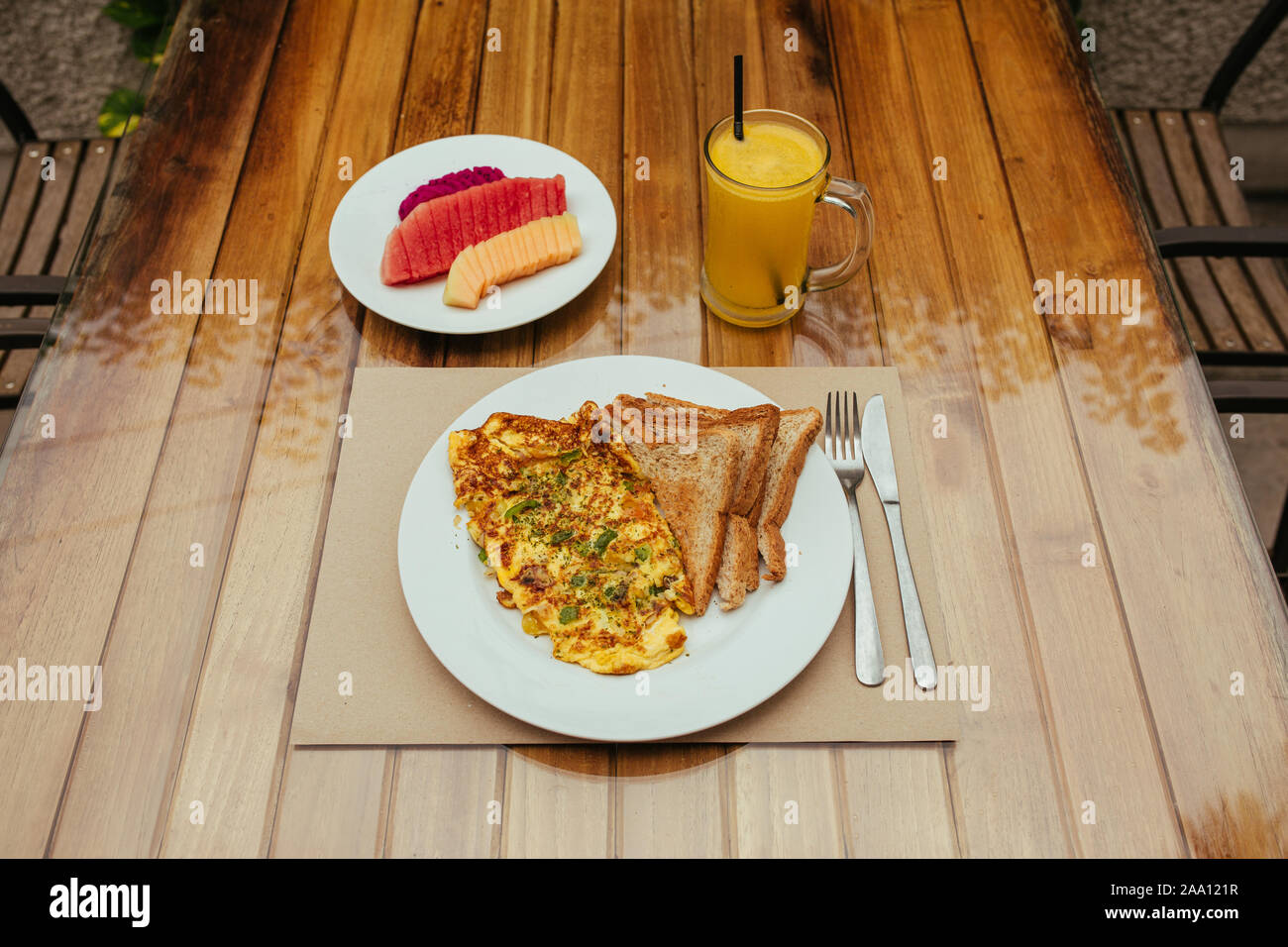 Omelet with vegetables, bread toast and fresh Juice on white a plate Stock Photo