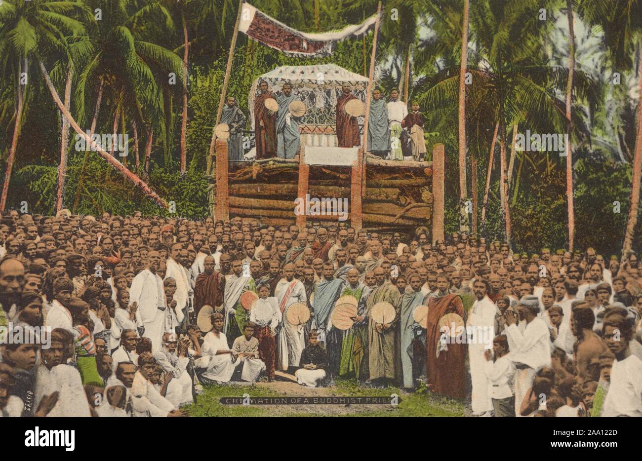 Illustrated postcard of a large crowd of Buddhist monks attending a cremation ceremony, Sri Lanka, published by A.W.A. Plate and Co, 1915. From the New York Public Library. () Stock Photo