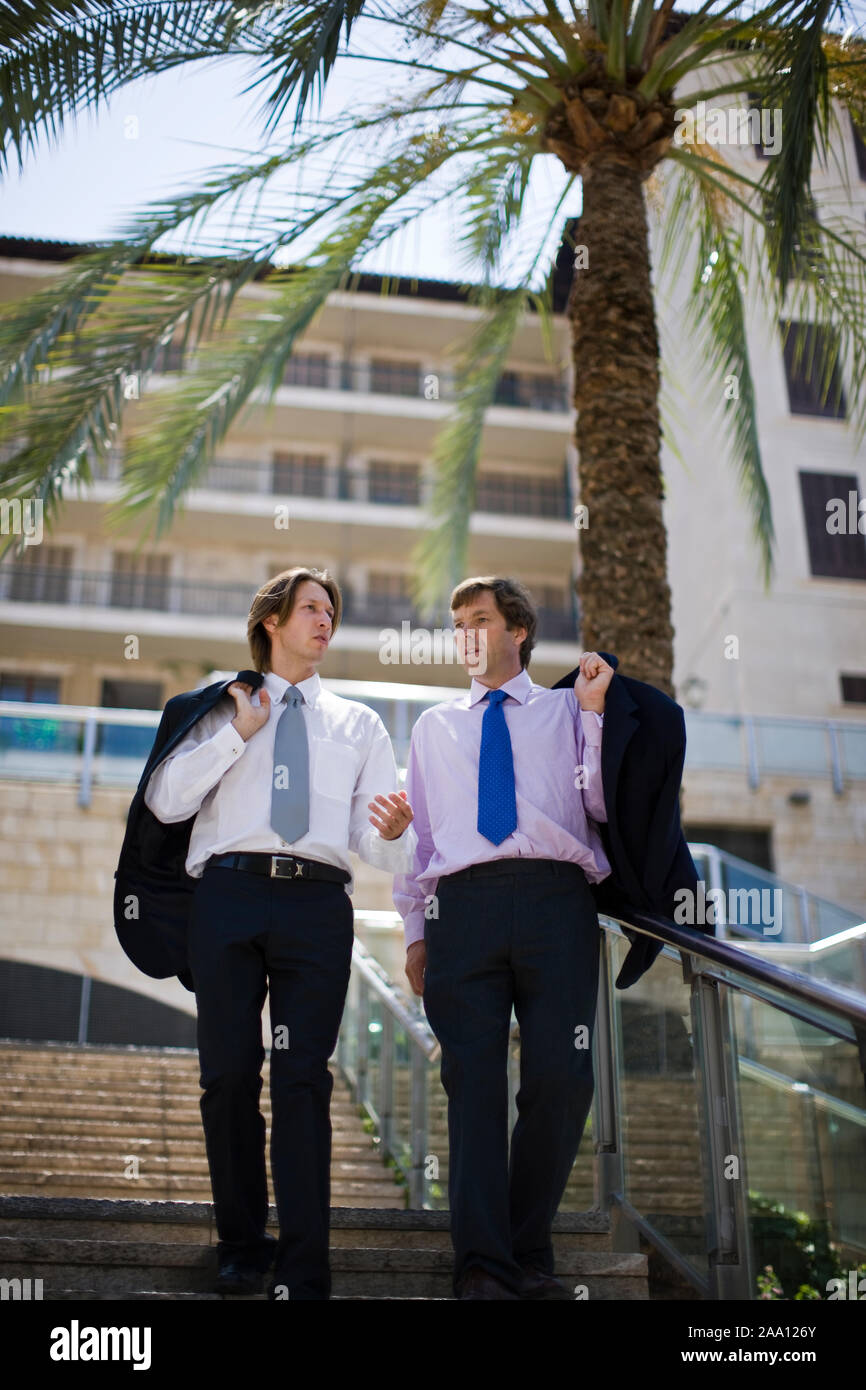 Two businessmen walking down steps in the city Stock Photo - Alamy