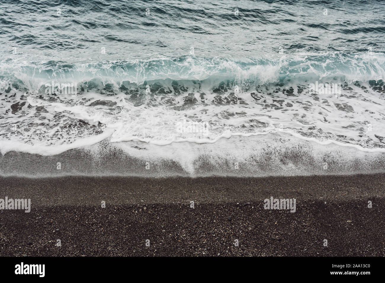 sea waves with white foam on beach in coastline Stock Photo - Alamy