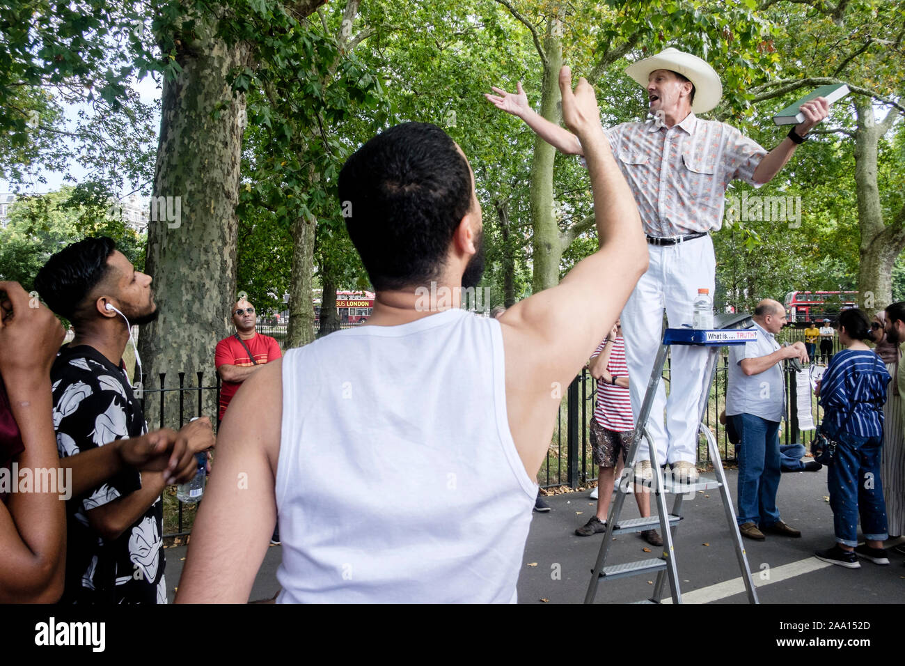 American, Christian religious evangelist is heckled by muslim youths