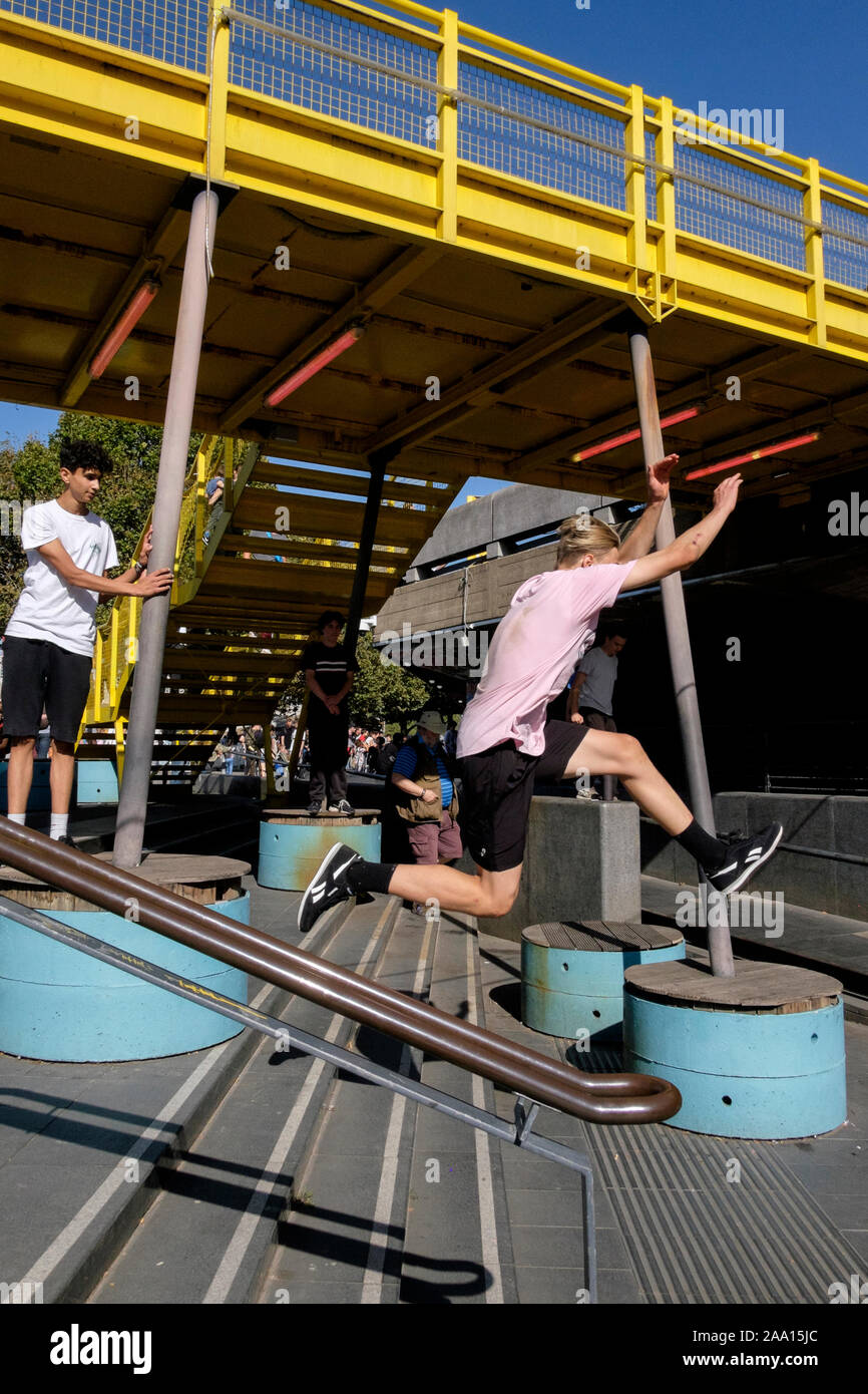 Teenage boys practise parkour at the South Bank area of London, UK Stock Photo