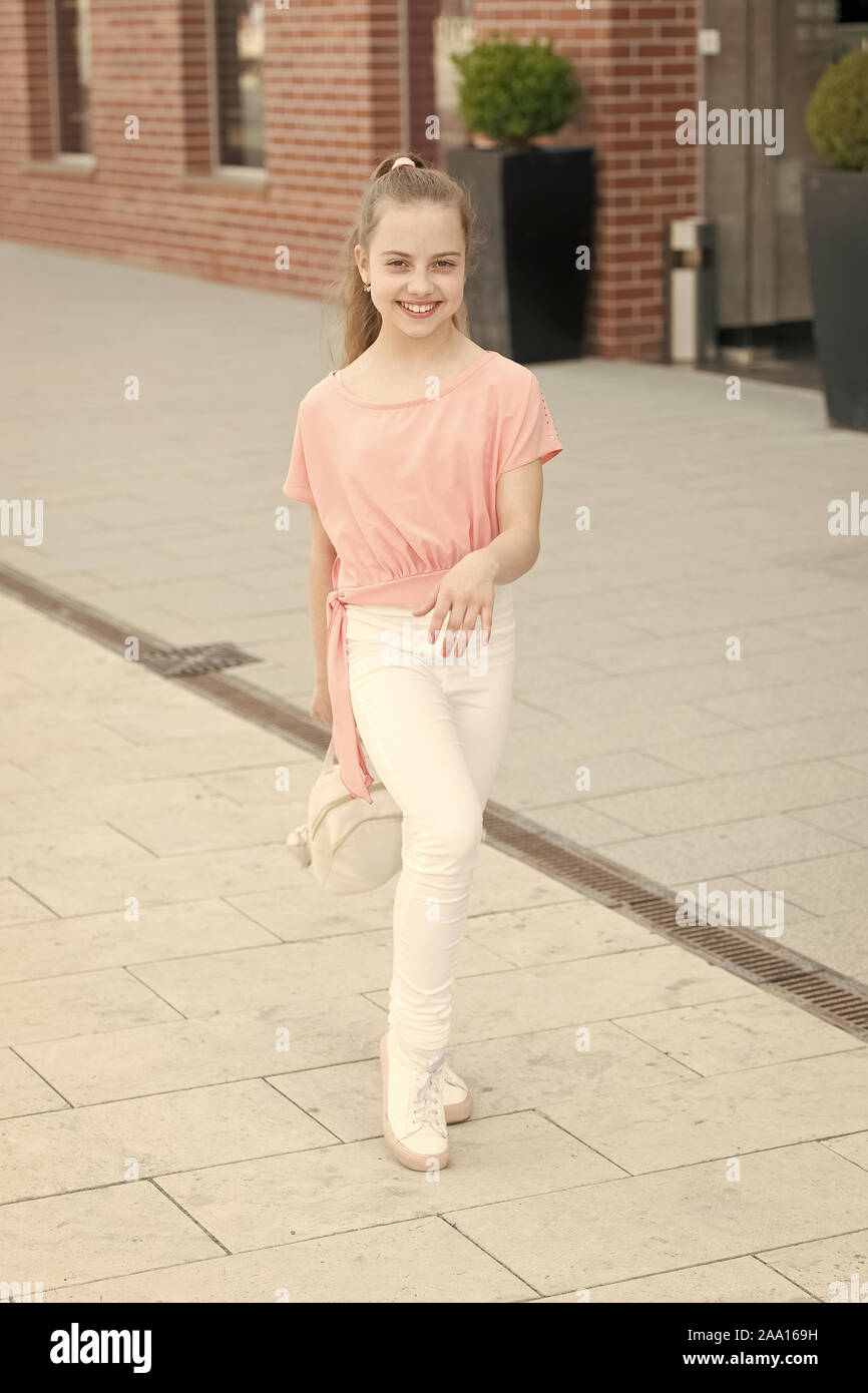 Casual clothing everyday living. Happy small girl walking in casual and comfy outfit. Little cute child smiling in casual style. Casual and comfortable Stock Photo Alamy
