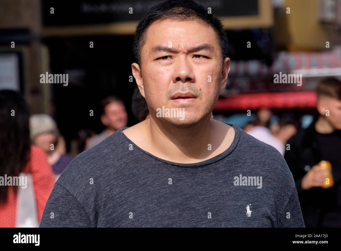 London street: male, 40s, casual dress, ethnic Chinese. Stock Photo