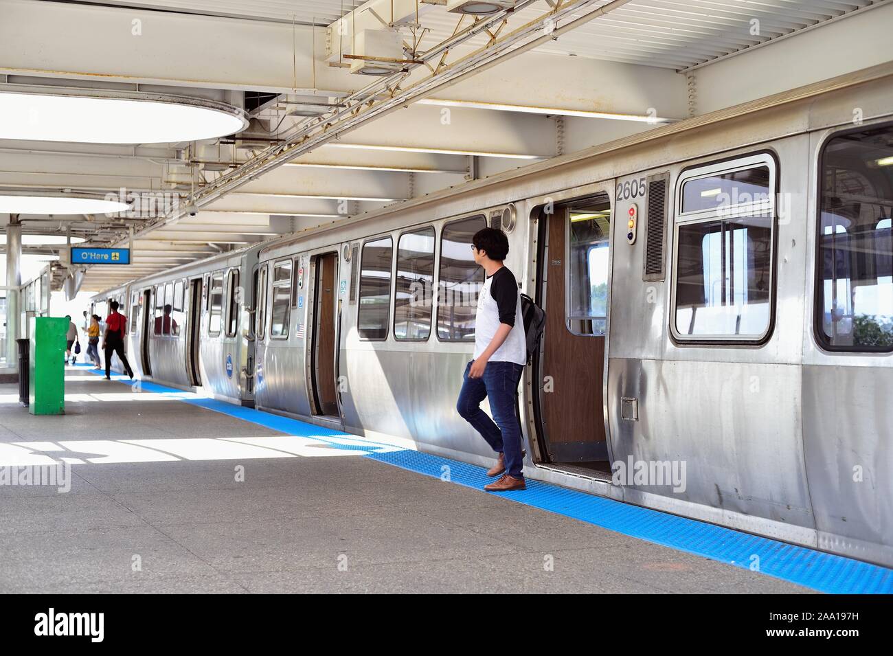 Chicago, Illinois, USA. Passengers exit a CTA Blue Line rapid transit train at the Rosemont Station on its journey to O'Hare International Airport. Stock Photo