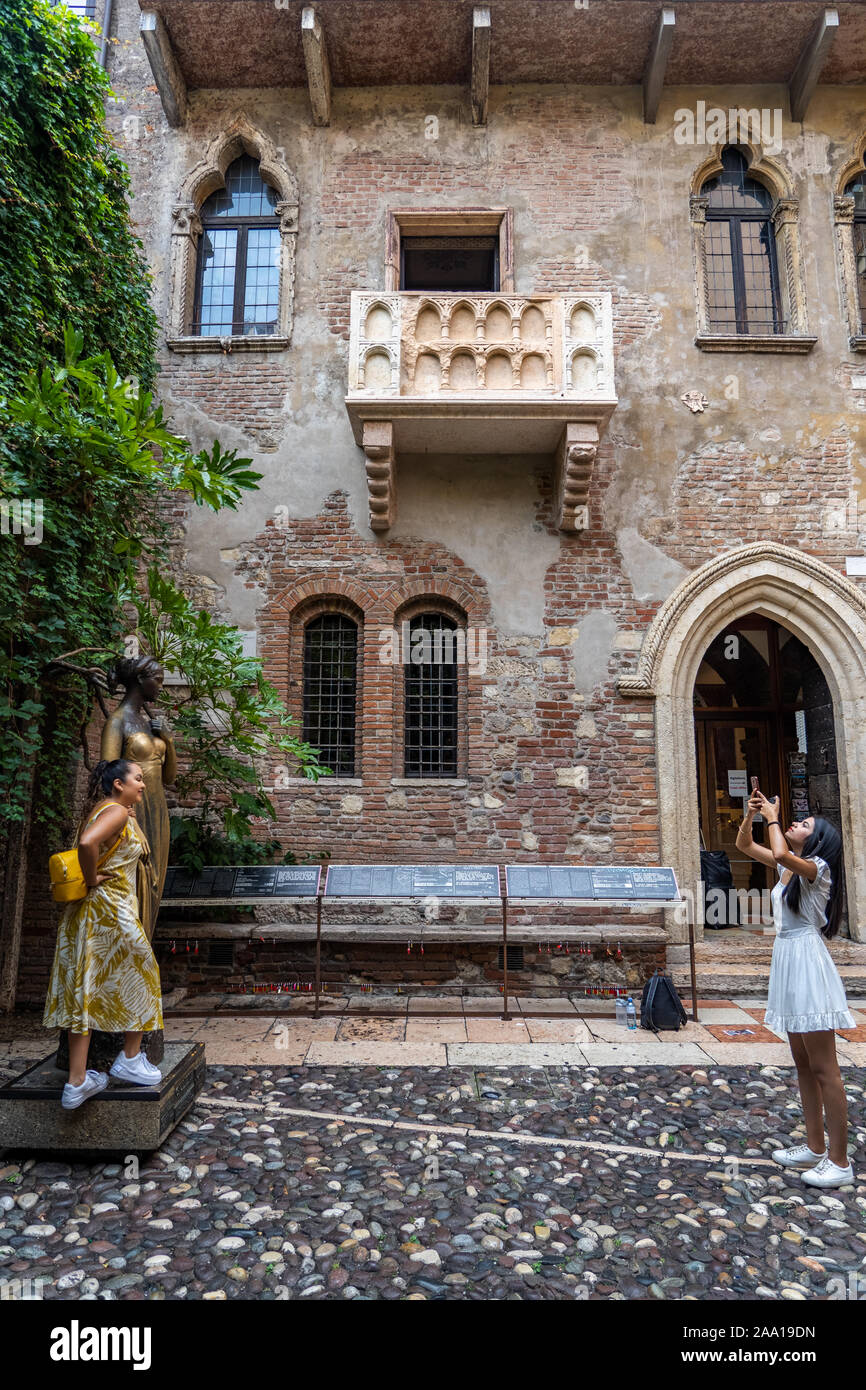 Verona, Italy - August 6, 2019: Tourists take photo with bronze statue of Guilietta, from romeo and juiliet Stock Photo