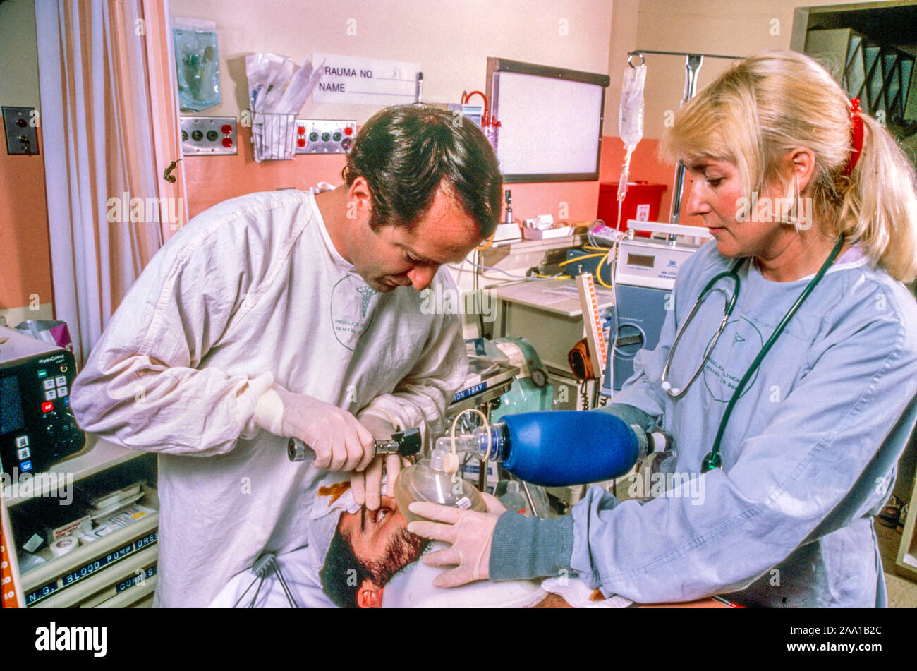 A doctor and trauma nurse administer anesthesia to an emergency room patient in Mission Viejo, CA. Stock Photo