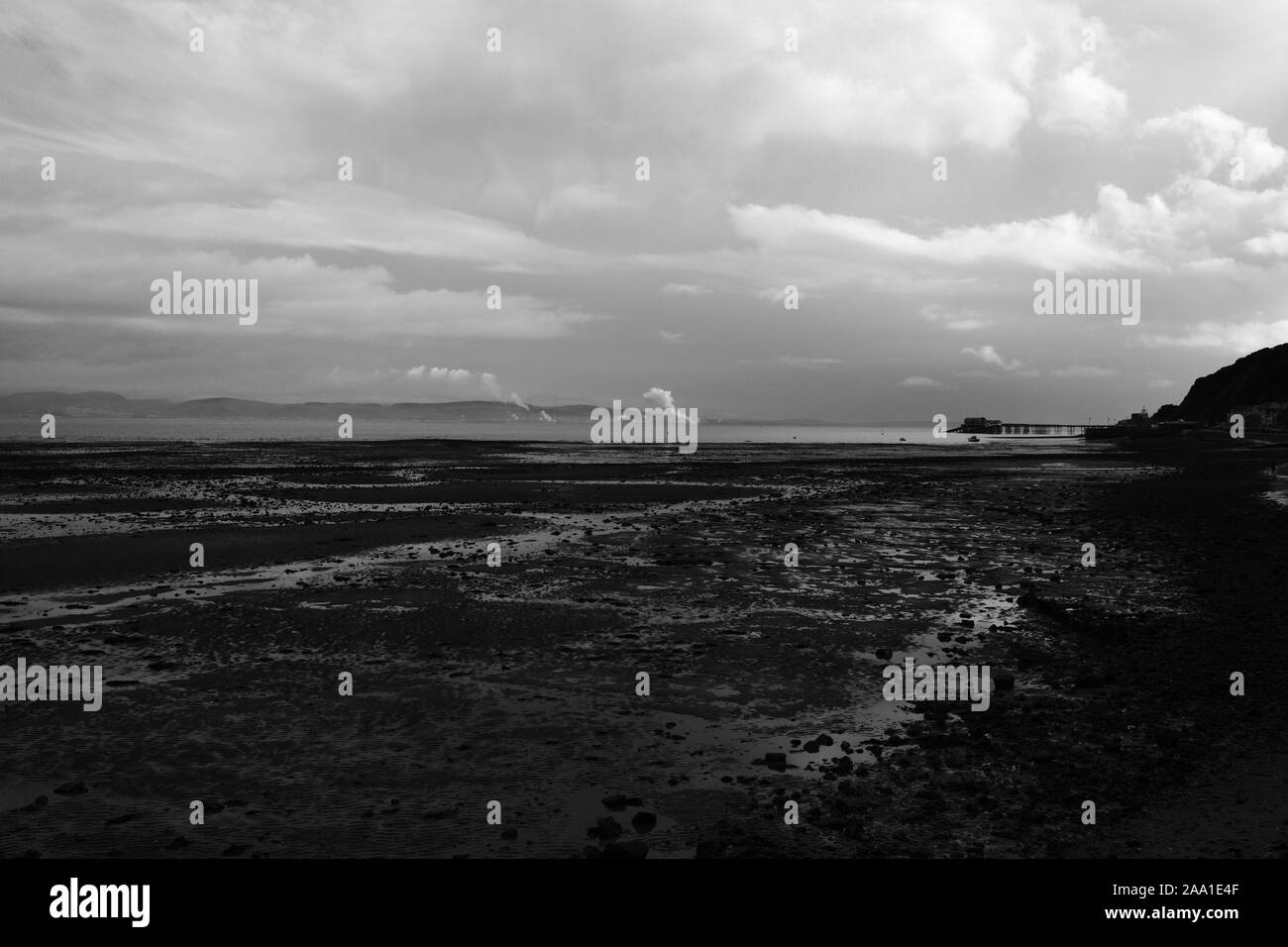 Looking East across Swansea Bay towards Port Talbot Steel Works and plumes of steam from the blast furnaces on the horizon at the Tata Plant Stock Photo