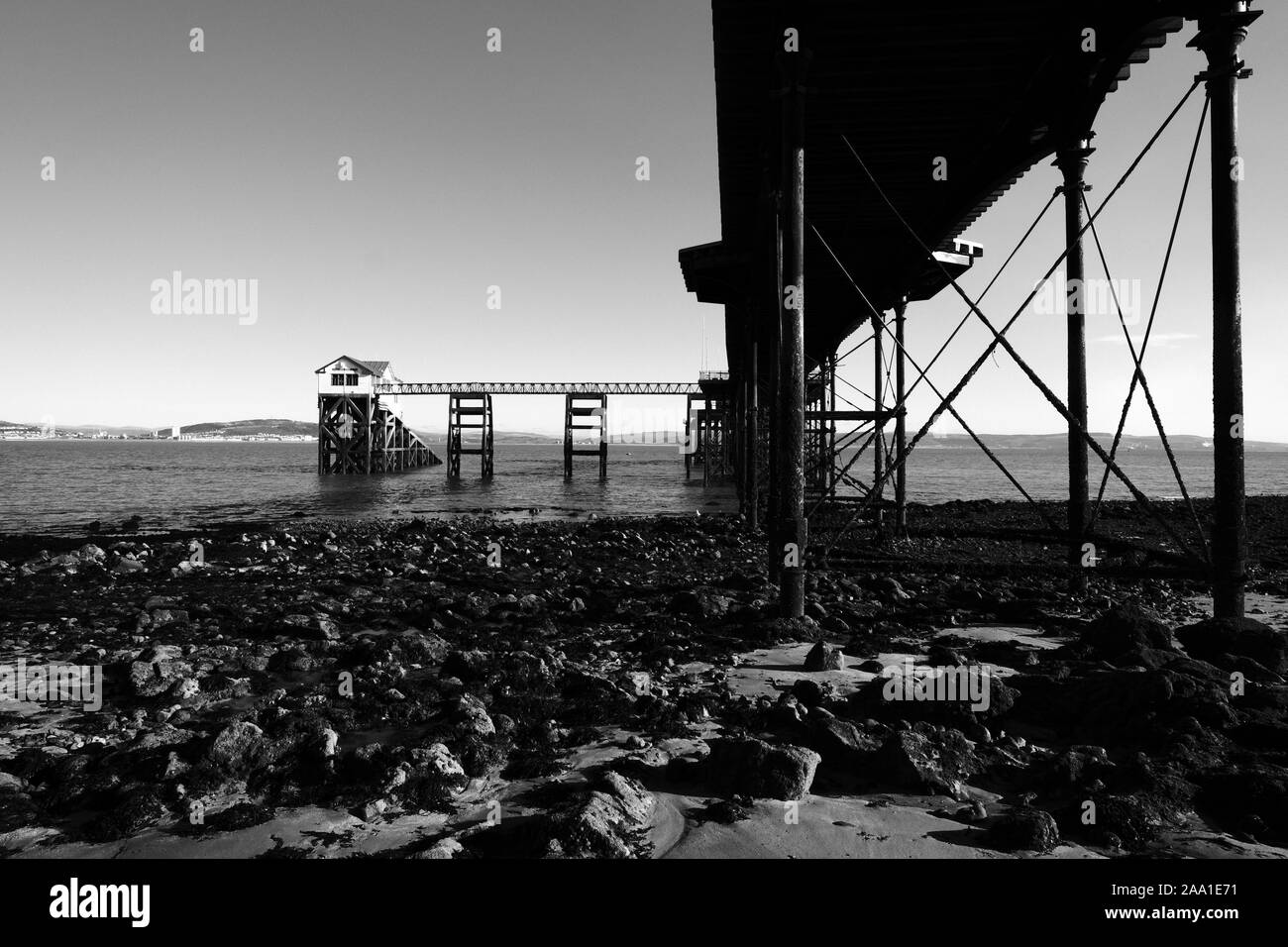 The Mumbles Pier and Swansea Bay at low tide in good calm winter weather on a sunny day in monochrome black and white Stock Photo