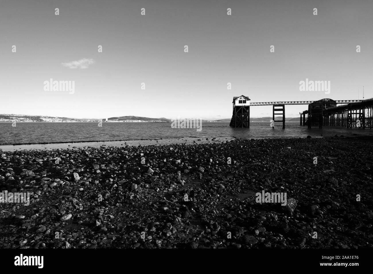 The Mumbles Pier and Swansea Bay at low tide in good calm winter weather on a sunny day in monochrome black and white Stock Photo