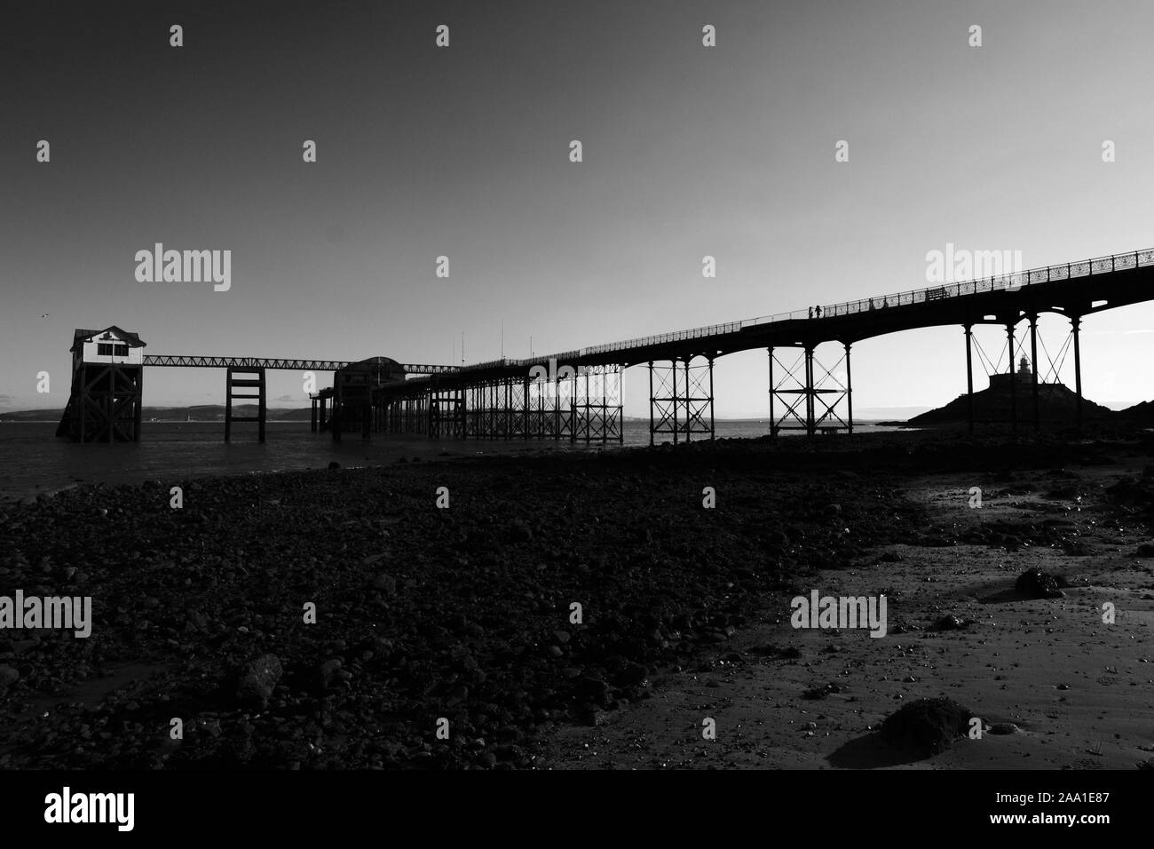 The Mumbles Pier and Swansea Bay at low tide in good calm winter weather on a sunny day in monochrome black and white Stock Photo