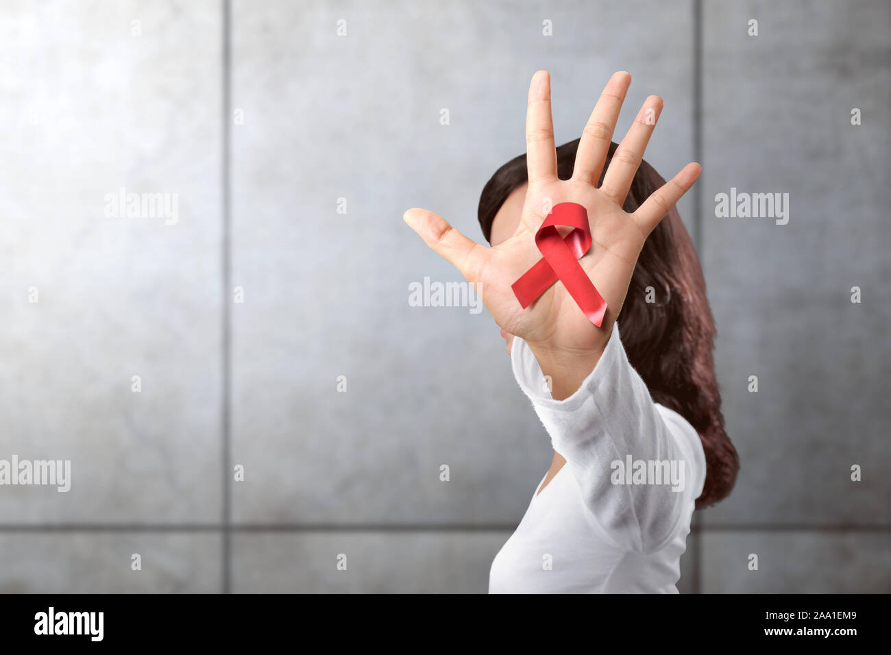 Woman in a white shirt showing a red ribbon. Hiv Aids ribbon awareness ...