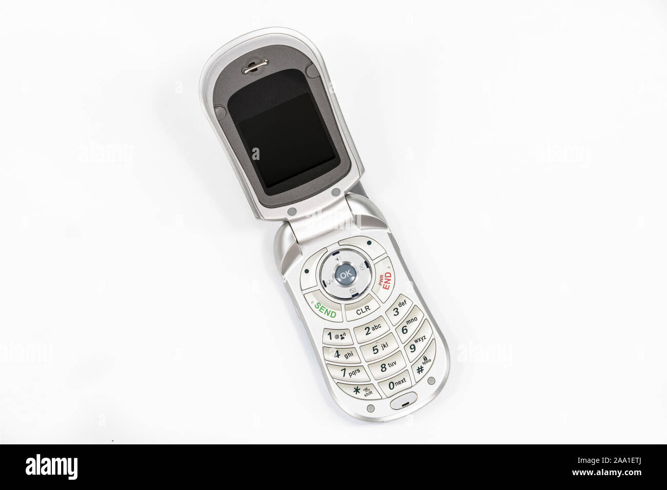 Cute little old flip style cell phone with white background. Stock Photo