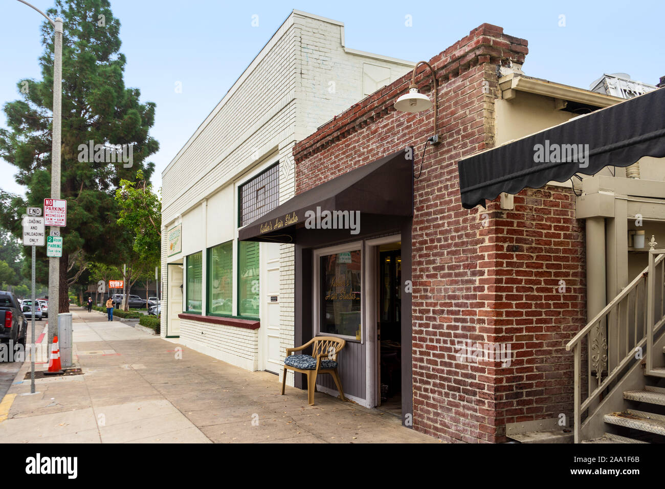 Santa Ana, CA / USA – November 14, 2019: Vintage brick buildings located in the City of Orange, California and home to Kistler's Hair Studio and the A Stock Photo