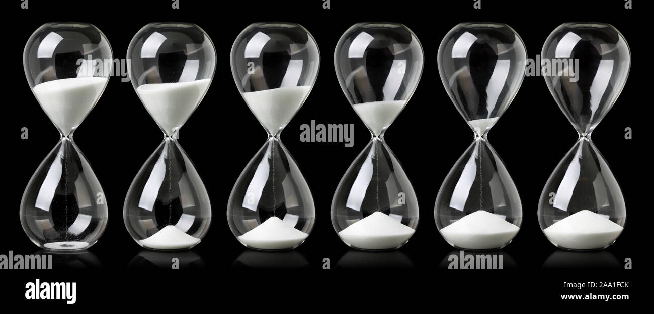 Collection of hourglasses with white sand showing the passage of time ...