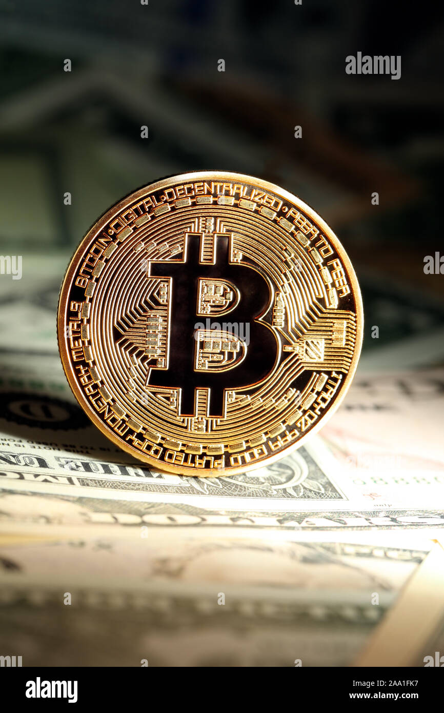 Shiny bright golden bitcoin, balanced on piles of money. Wealth, digital,  virtual, currency, and cryptocurrency concept Stock Photo - Alamy