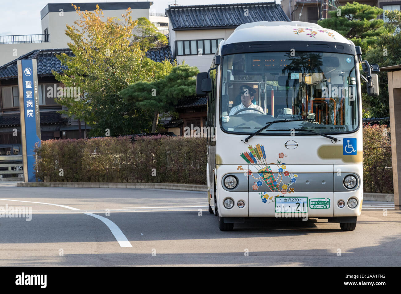 Japanese public bus with the driver wearing hat at the center of Kanazawa, Japan. Stock Photo