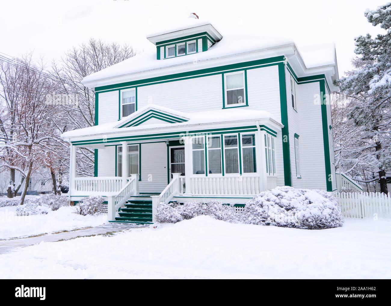 Older traditional style home after a snowfall. Stock Photo
