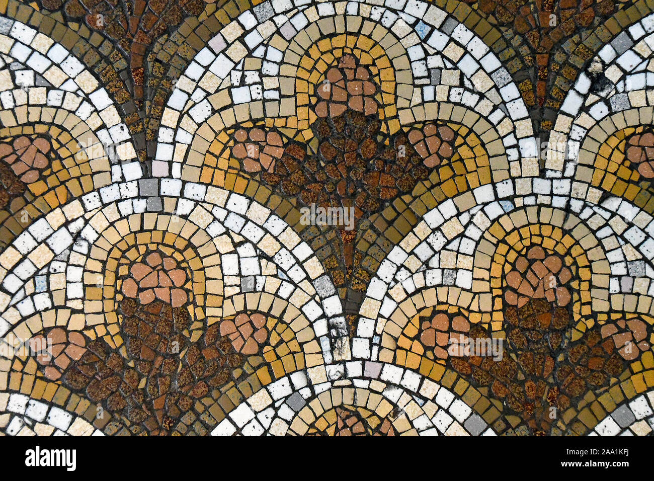 brown and gold ornate mosaic tile floor pattern Stock Photo