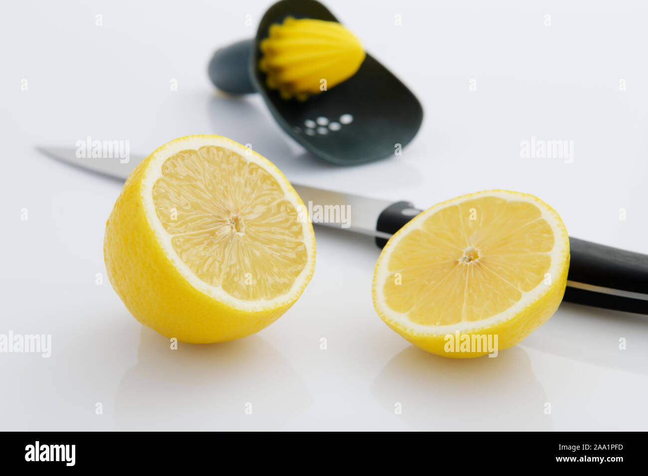 Fresh lemon sliced with knife to make juice, home cooking, food preparation, healthy natural