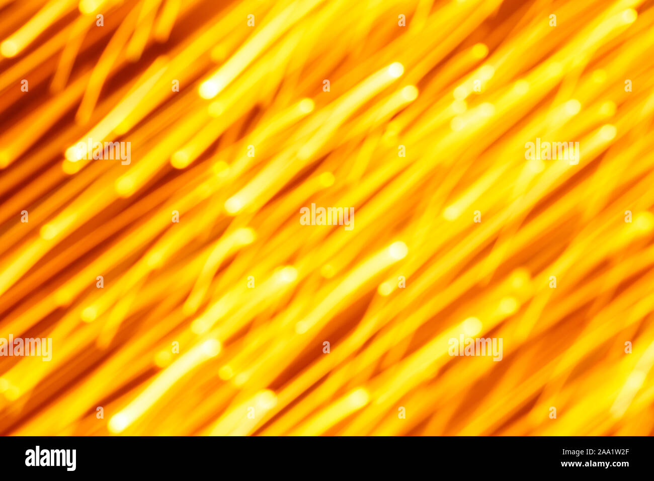 Futuristic blurred lights holiday monochrome background in yellow. Horizontal, soft focus Stock Photo