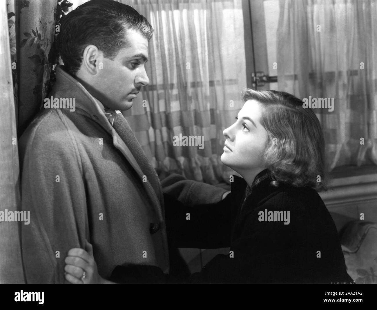 LAURENCE OLIVIER as Maxim de Winter and JOAN FONTAINE as the second Mrs. de Winter in REBECCA 1940 director ALFRED HITCHCOCK novel DAPHNE DU MAURIER producer DAVID O. SELZNICK  Selznick International Pictures / United Artists Stock Photo