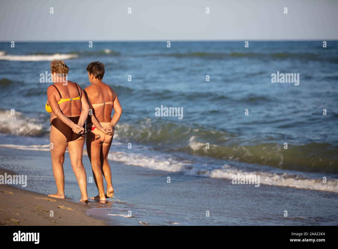 Ukraine, August 30, 2019. Odessa. City beach. Ordinary elderly women walk along the seashore. Relax on the beach. Stock Photo
