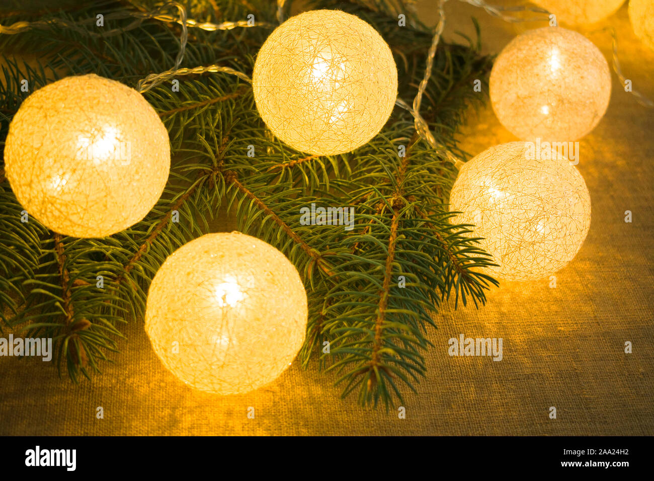 Christmas background of fir branches and luminous balls Stock Photo - Alamy