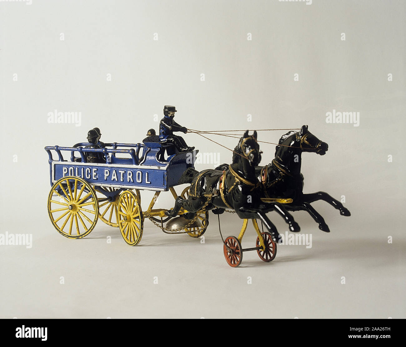 Childrens toys from the past. A cast iron toy made in USA with two horses pulling a police patrol wagon. Simple but fun toys that were cheap to buy. They are now collectible and can be very valuable. Stock Photo