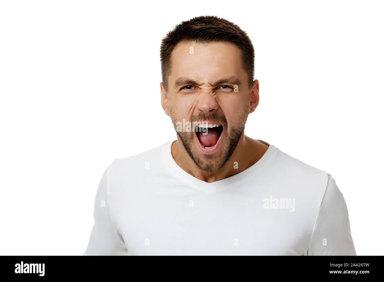portrait of furious enraged bearded man in casual white shirt shouting and screaming isolated on white background Stock Photo