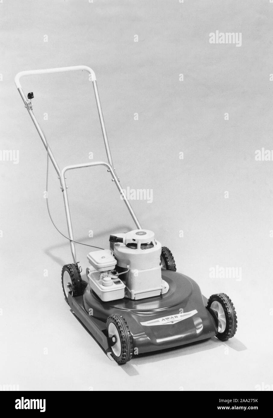 Garden equipment of the 1960s. A motor driven lawn mover in a photographers studio. The model has a 2-stroke Briggs & Stratton engine and a lever on the handle manouvres the engine throttle. Sweden 1960s Stock Photo