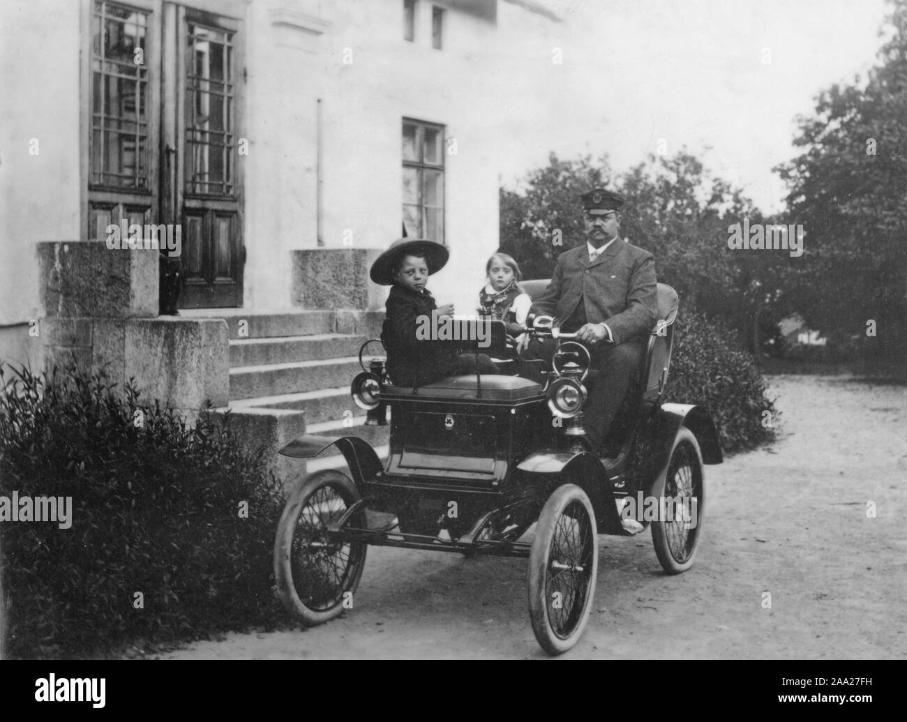 Motoring history. A proud man and father sits in his new car together with his two children. Unkown model. Picture taken in Lindesberg Sweden 1903 Stock Photo
