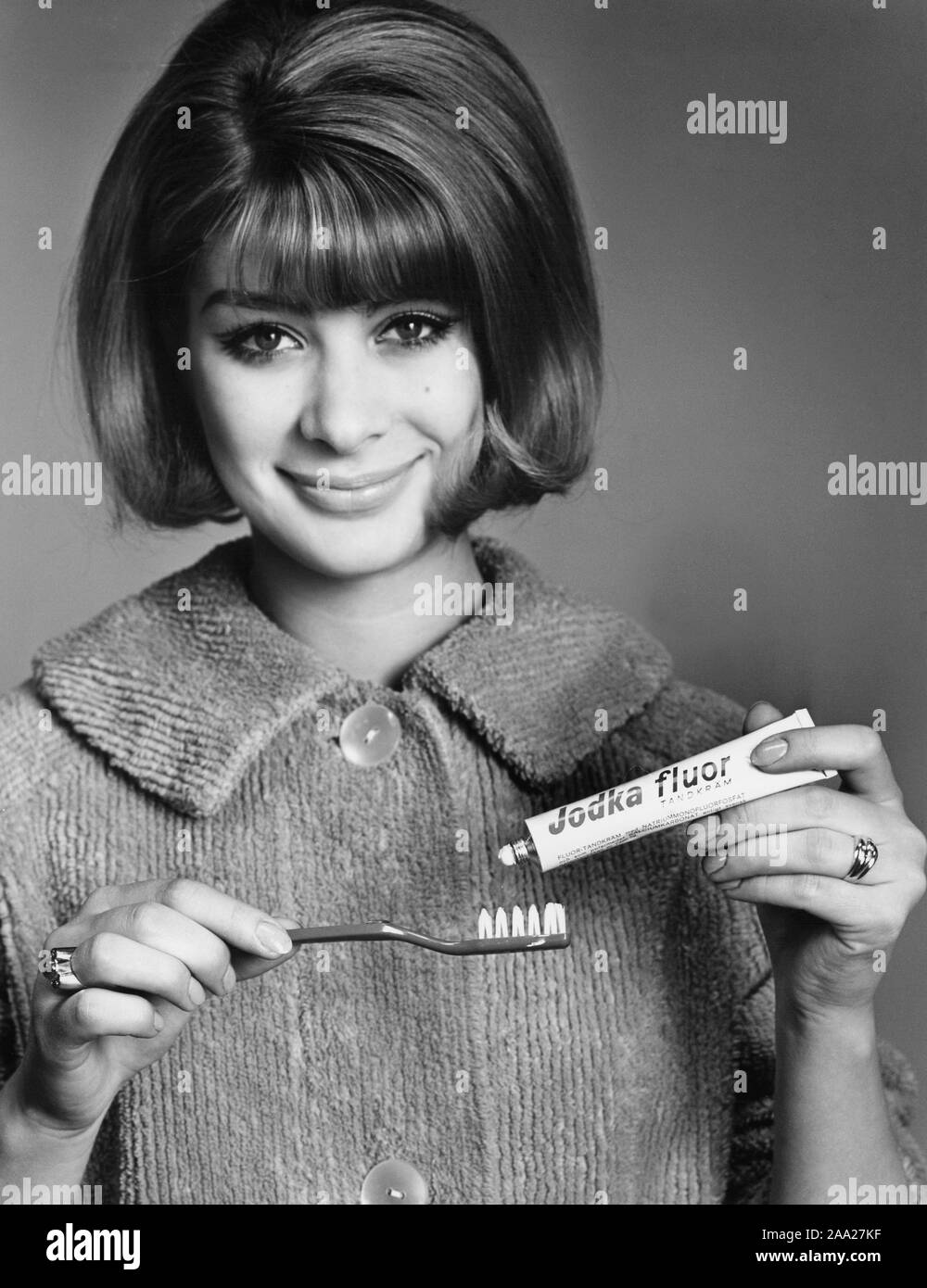 Woman in the 1960s. She is putting toothpaste on her toothbrush. Sweden 1966 Stock Photo