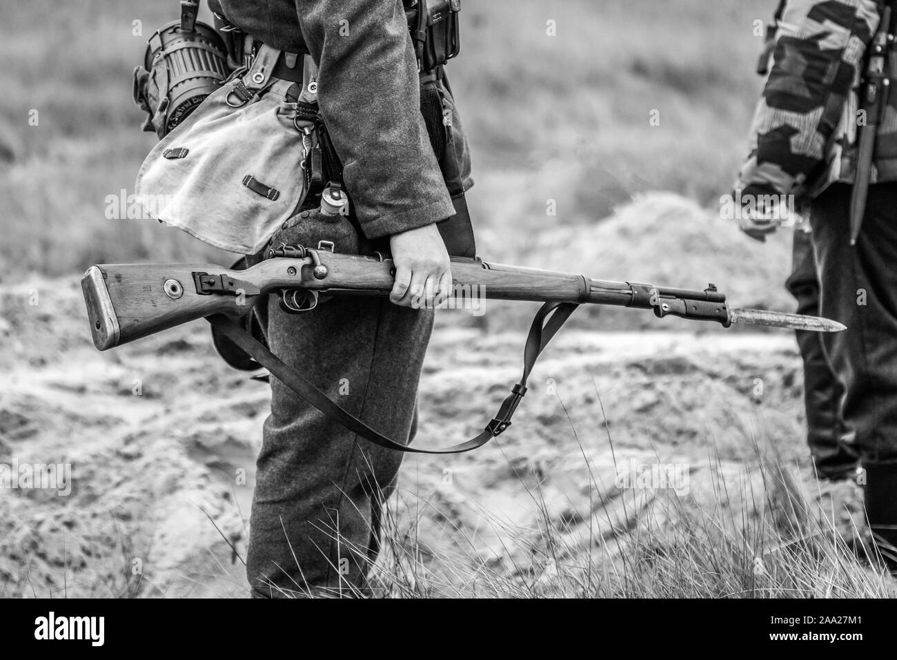 A rifle with a bayonet with a knife in the hands of a Wehrmacht soldier ...