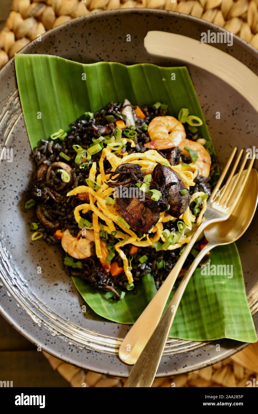 Nasi Goreng Cumi Hitam. Indonesian dish of rice stir-fried with braised squid and its in. Stock Photo