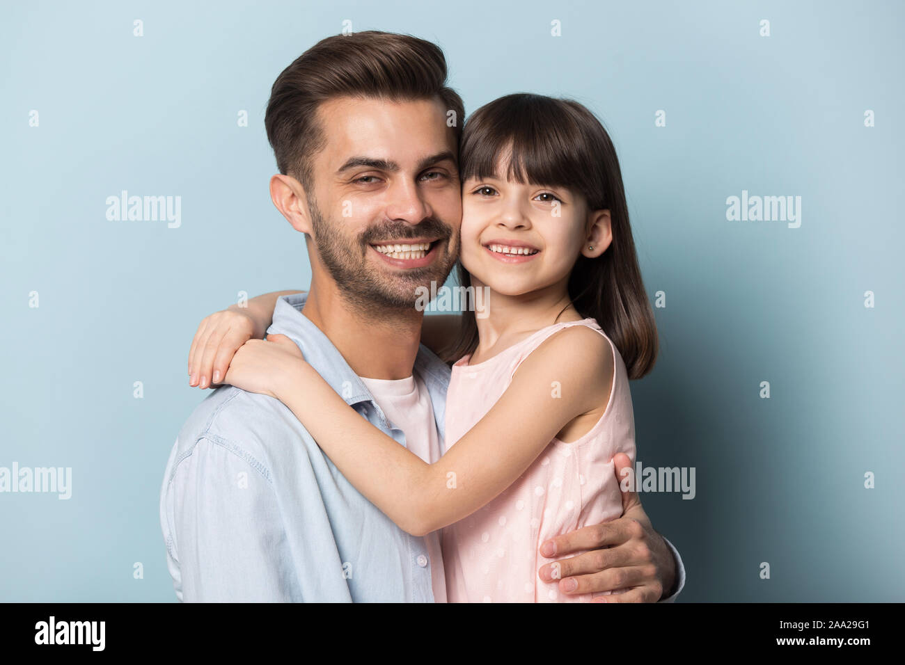 Close up portrait with happy parent and little brown-haired girl. Stock Photo